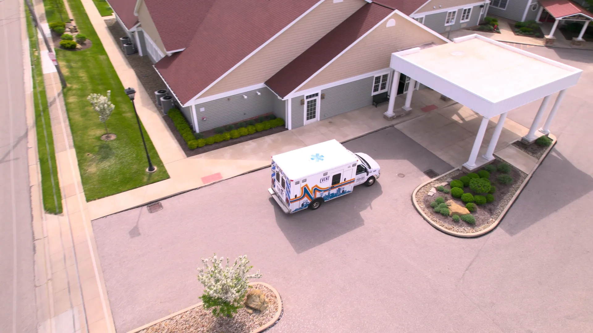 Aerial drone shot of an EMS ambulance at the covered main entrance