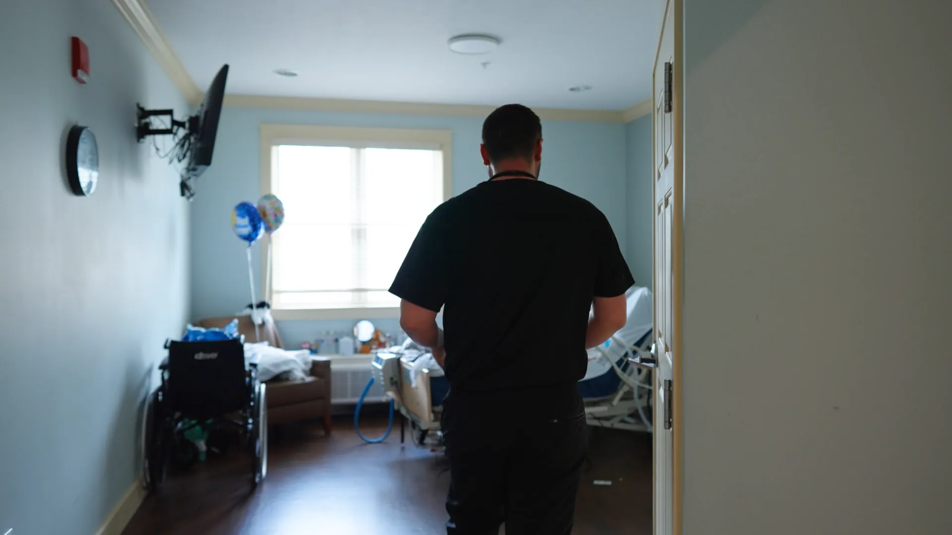 Staff member entering a private patient room with residential touches